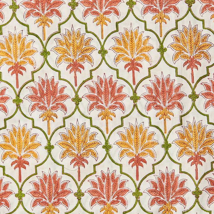 an orange and green flower pattern on white fabric