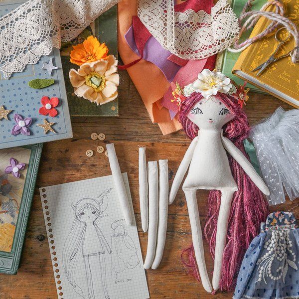 an assortment of crafting supplies on a wooden table