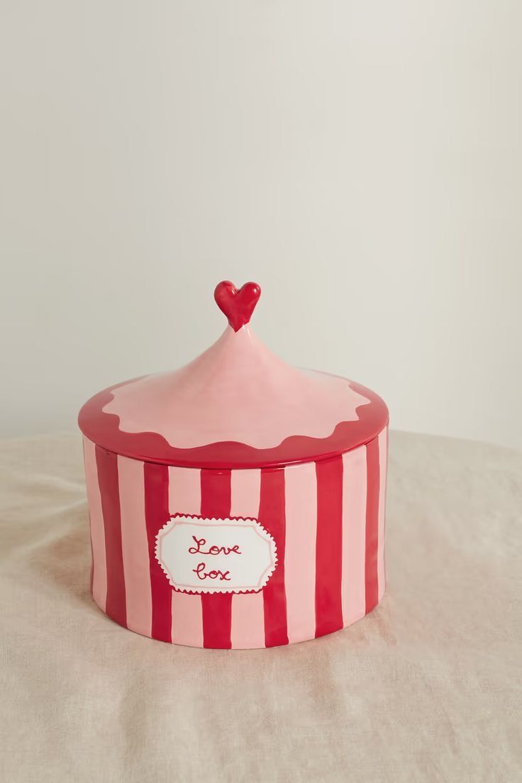 a red and white striped box with a heart on top