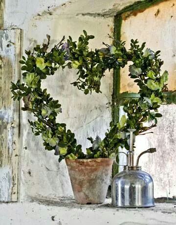 a potted plant sitting on top of a window sill next to a bell