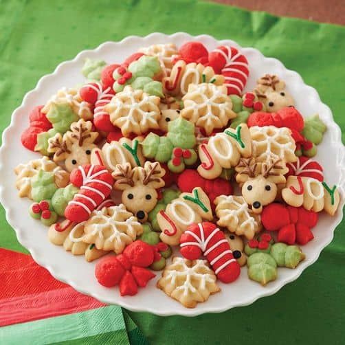 a plate full of decorated christmas cookies on a table