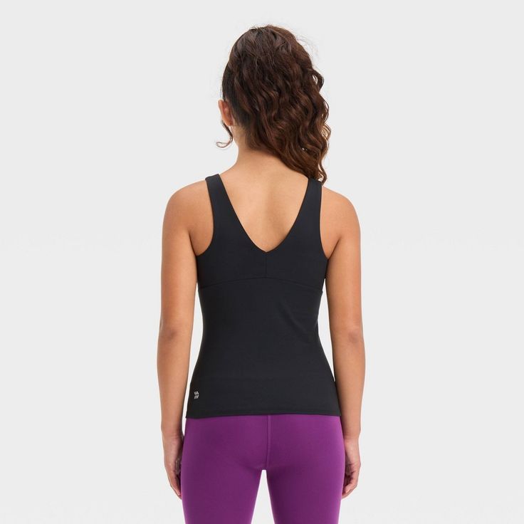 Why we're ALL IN: Solid-color athletic tank top with flat seams keeps them comfortable during any activity. Crafted from recycled polyester with spandex and a UPF 50+ rating to keep them feeling cool and fresh and shield them from the sun. Tailored in a fitted, below-hip length hip with a V-neck front and back for a sporty vibe. All in Motion™: Made for every move, priced for every day. Versatile Sleeveless Nylon Activewear, Breathable High Stretch Sporty Tank Top, Sporty Breathable High Stretch Tank Top, Moisture-wicking High Stretch Tank Top For Sportswear, Breathable Stretch Tank Top, Athleisure High Stretch Nylon Tank Top, High Stretch Nylon Tank Top For Athleisure, High Stretch Moisture-wicking Tank Top For Sportswear, High Stretch Nylon Athleisure Tank Top