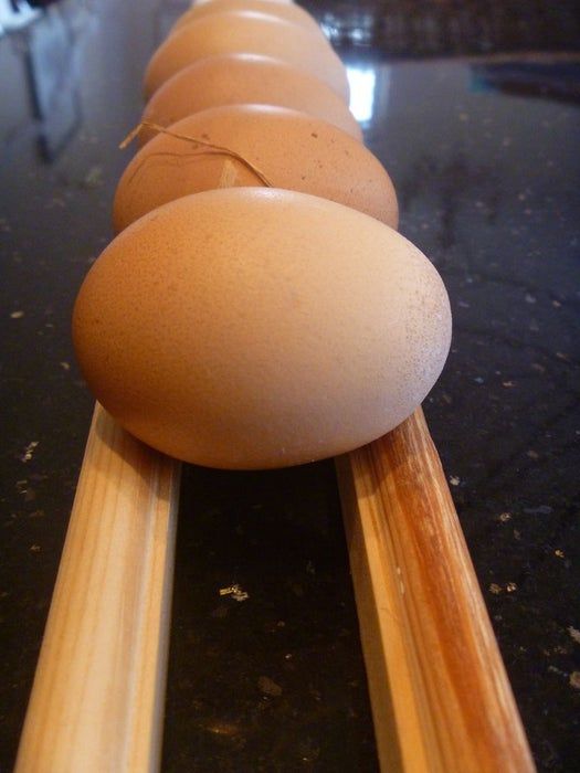 an egg is laying on top of some wooden dows and ready to be put in the oven