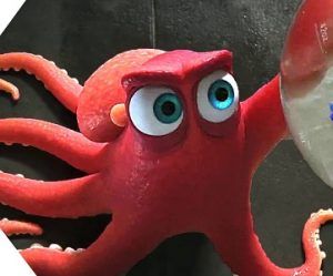 an octopus with googly eyes is holding a toothbrush