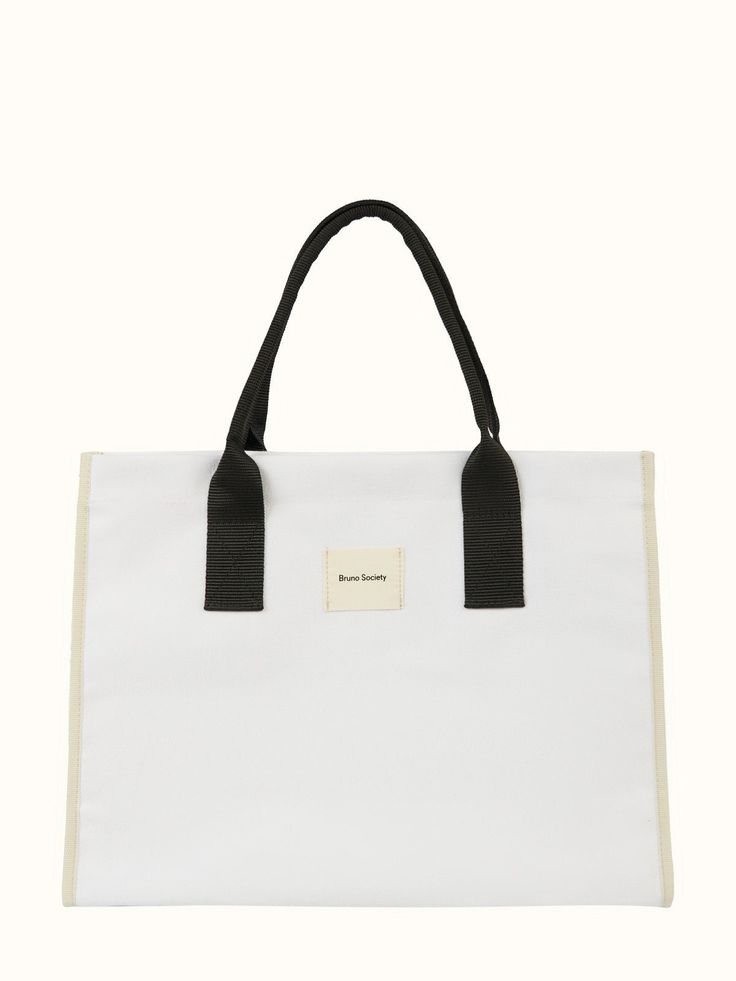 a white tote bag with black handles