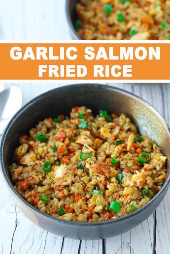 garlic salmon fried rice in a skillet with carrots and green onions on the side