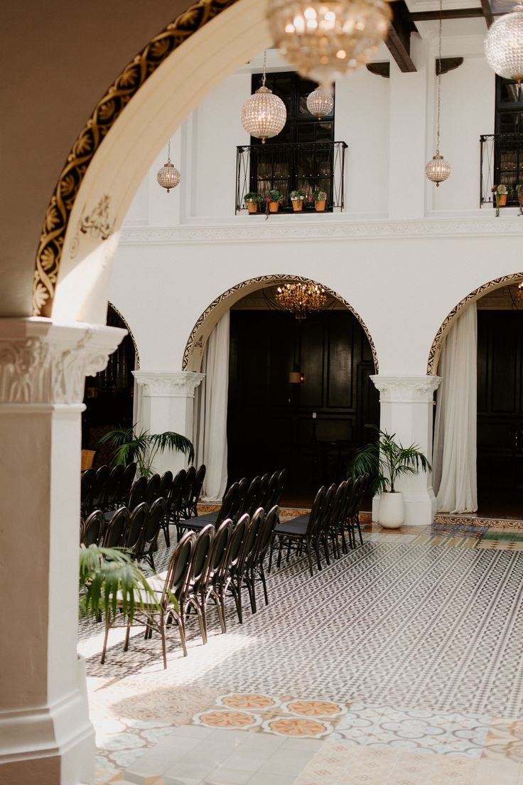 rows of chairs are lined up in front of an archway