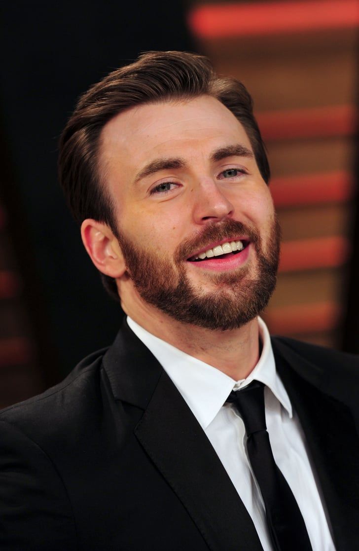 a man in a suit and tie smiles at the camera