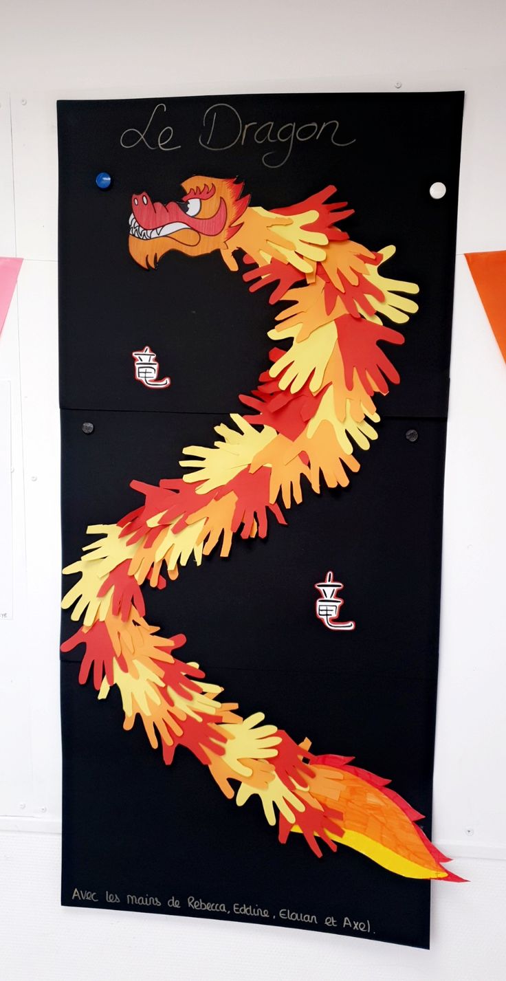 a black wall with an orange and yellow fire dragon on it's left side