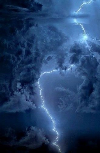 a large cloud with lightning striking through it