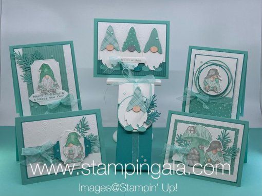 some cards are stacked on top of each other with christmas trees in the background and snowflakes around them