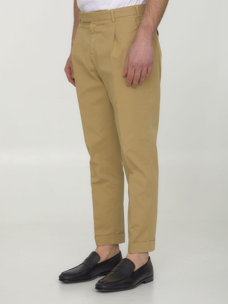 Ankle-cropped trousers in beige cotton gabardine. It features zip, button and hook-and-eye closure, two side welt pockets, two rear buttoned flap pockets and belt loops. The model is 188cm tall and wears size 48.Size nationality: IT Product number: 38284533 Product code: CORTZAZ40FWINU35Y052 Composition: 98% COTTON, 2% ELASTANE Beige Tapered Leg Chinos With Belt Loops, Tapered Chinos With Belt Loops, Tapered Leg Chinos With Belt Loops In Cotton Twill, Tapered Straight Chinos With Belt Loops, Chino Cotton Twill Bottoms With Belt Loops For Workwear, Chino Cotton Twill Workwear Bottoms With Belt Loops, Beige Chino Cotton Twill Bottoms With Belt Loops, Chino Cotton Twill Trousers With Belt Loops, Beige Chinos For Work With Straight Hem