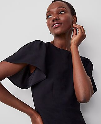 Elevate your wardrobe with the Ann Taylor Flutter Sleeve Flare Dress, a piece that marries elegance with comfort. This dress features a flattering flare silhouette that ensures you stay at the top of the style game.

- Size: 12
- Color: Black
- Gender: Female
- Material: 100% Polyester
- Length: 20 inches from natural waist
- Features: Crew neck, short sleeves with shirred caps, hidden back zipper with hook-and-eye closure
- Care: Machine washable

Perfect for both office days and evening events Fit And Flare Short Sleeve Dress For Workwear, Fit And Flare Short Sleeve Work Dresses, Black Fit And Flare Midi Dress With Short Sleeves, Elegant Black Flutter Sleeve Top, Black Non-stretch Short Sleeve Dress, Black Flare Dress, Elegant Black Dress, Flare Top, Blazer And Skirt