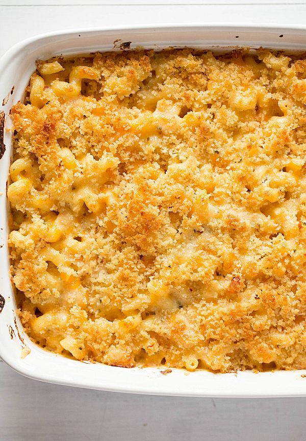 a casserole dish filled with macaroni and cheese on a white table