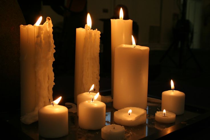 several lit candles sitting on top of a table