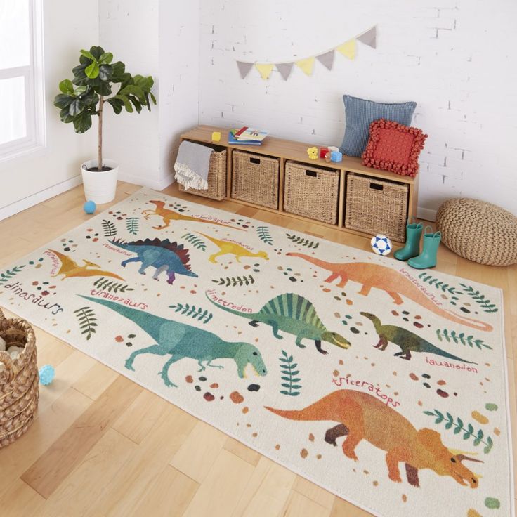 a child's room with dinosaur rugs and toy bins on the floor