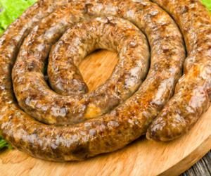 two sausages on a cutting board with lettuce