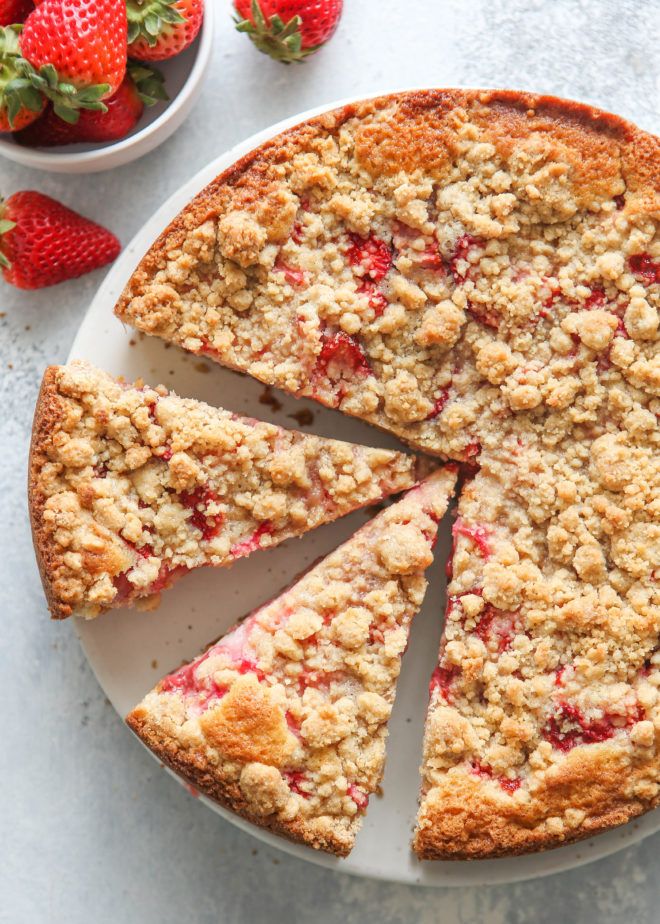 a strawberry crumb cake cut into slices on a plate