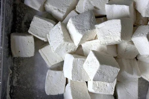 there are many pieces of white marshmallows in the pan