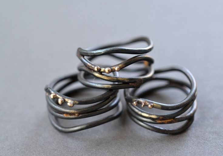 Organic wrap rings, reminiscent of vines,  are fabricated from forged steel wire that has been brazed together with brass and accented with small beads of recycled 10k gold.  Available in whole and half sizes, 4-11.  Rings are around 12mm across at their widest point.  Note Because of the width of the rings its recommended to order a half size larger than you normally would. Due to the handmade nature of these rings, each one is unique and exact design will vary from the photo. Steel has been se Wrap Around Ring, Interlocking Circle Necklace, Gold Circle Necklace, Blackened Steel, Wide Ring, Ring Hand, Wrap Ring, Wire Rings, Wide Rings