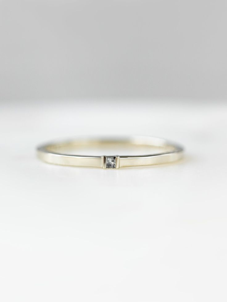 Why You'll Love It Our Blake Band is all about being unique with simplicity! A plain band with a salt and pepper diamond as the center focus. It is an everyday wear kind of ring that can be worn stacked all together or with other stackable bands. Details 14K solid gold Salt and Pepper 1.5 x 1.5mm Princess Diamond - 1 piece Band width is approx. 1.5mm Everyday Stackable Diamond White Diamond Ring, Timeless Stackable Diamond Ring For Everyday, Everyday Single Diamond White Diamond Ring, Everyday Stackable Diamond Rings With Single Diamond, Everyday Timeless Stackable Diamond Ring, Everyday Fine Jewelry Stackable Rings With Single Diamond, White Gold Stackable Rings With Single Diamond For Everyday, Everyday White Gold Stackable Ring With Single Diamond, Minimalist Diamond Band With Single Cut Diamonds