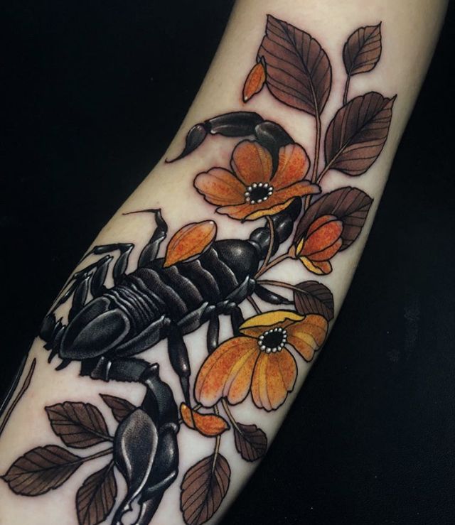 a scorpion tattoo on the arm with orange flowers and leaves around its neck, in front of a black background