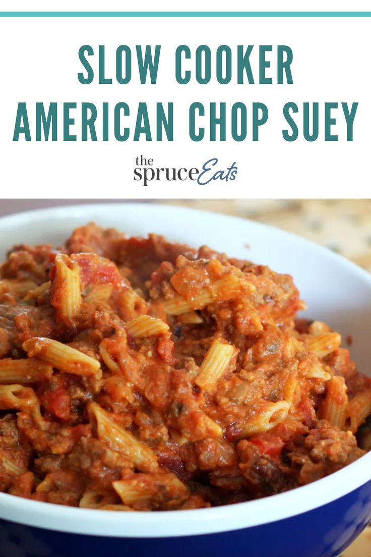 slow cooker american chop suey in a blue bowl with the title above it