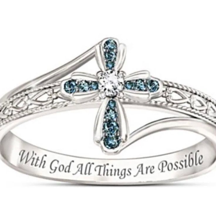 a blue diamond cross ring with the words,'why god all things are possible '