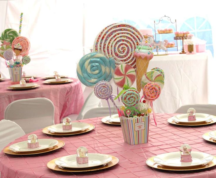 a table set up with candy and lollipops