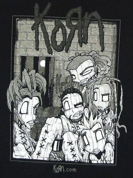 graffiti on the side of a building with people standing in front of it at night