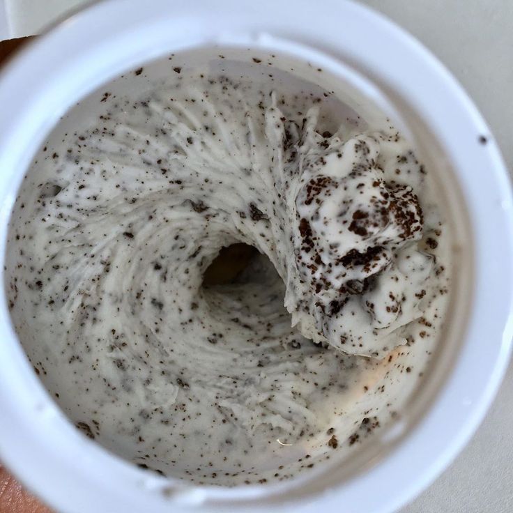 a white bowl filled with cream and brown stuff