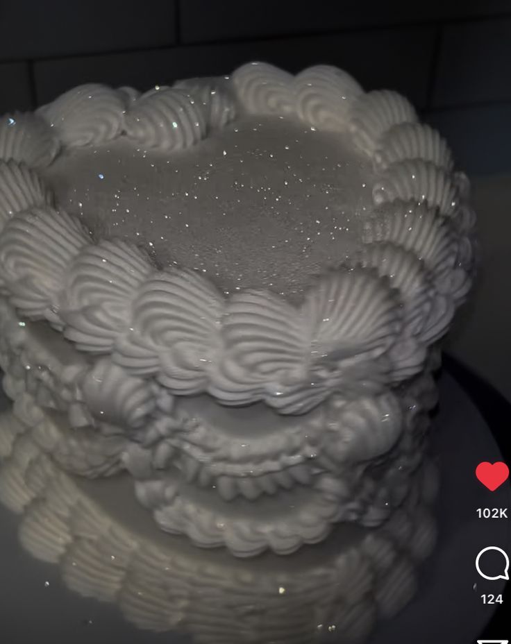 a white cake sitting on top of a glass plate