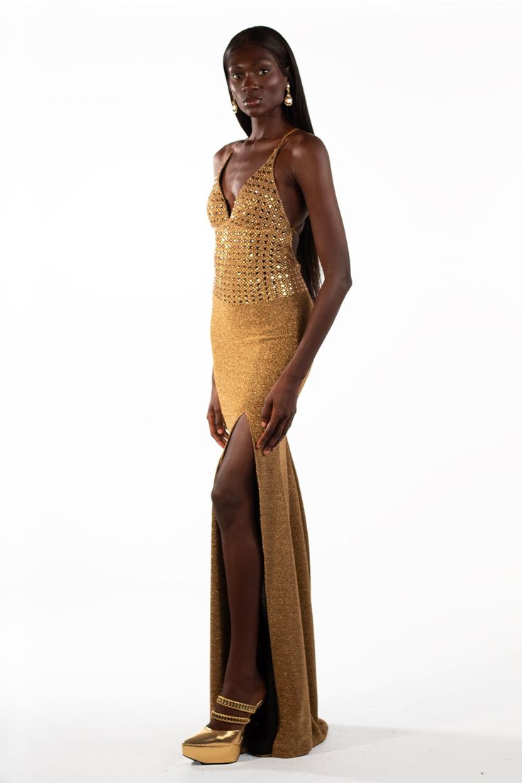 The Alison is a show-stopping statement piece, a maxi gown drenched in golden glamour. Picture yourself draped in cascading layers of crystalized rhinestones, each catching the light with an irresistible shimmer. The square neckline adds a touch of modern edge, while the metallic charm whispers of individuality. This isn't just a dress, it's a conversation starter. Be the epitome of audacious elegance – own your night in the Alison. Glamorous Gold Maxi Dress, Glamorous Gala Maxi Dress, Gold Sequin Dress For Prom And Gala, Gold Sequin Dress For Prom Gala, Gold Sequin Prom Dress For Gala, Luxury Gold Gown For Prom Season, Gold Sequin Dress For Gala, Luxury Gold Dress With Sweep Train, Glamorous Gold Sparkling Evening Dress