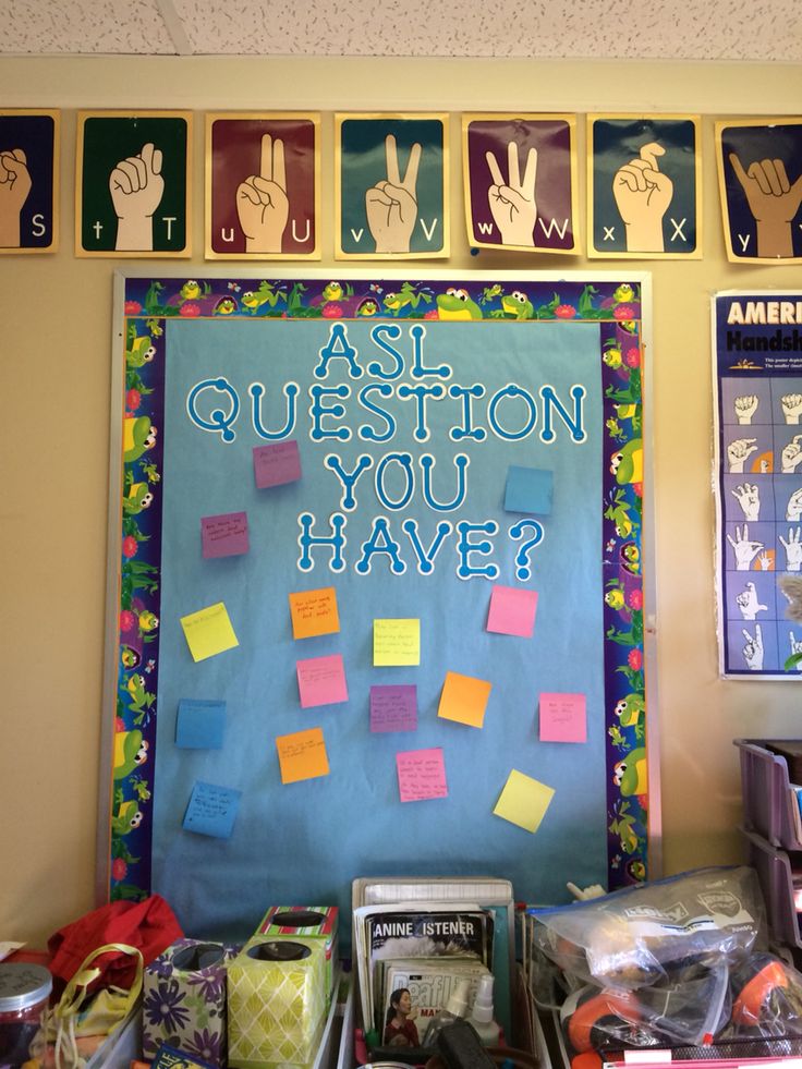 a bulletin board with post - it notes and handprints on it that says ask question you have?