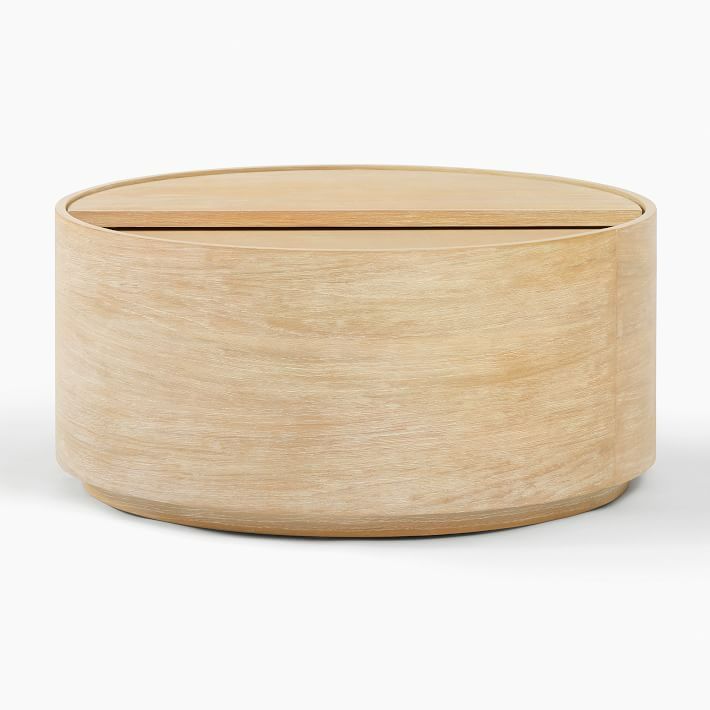 a round wooden box sitting on top of a white surface with a lid in the shape of a circle