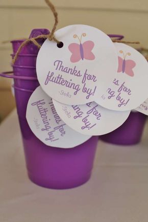 purple plastic cups with tags attached to them