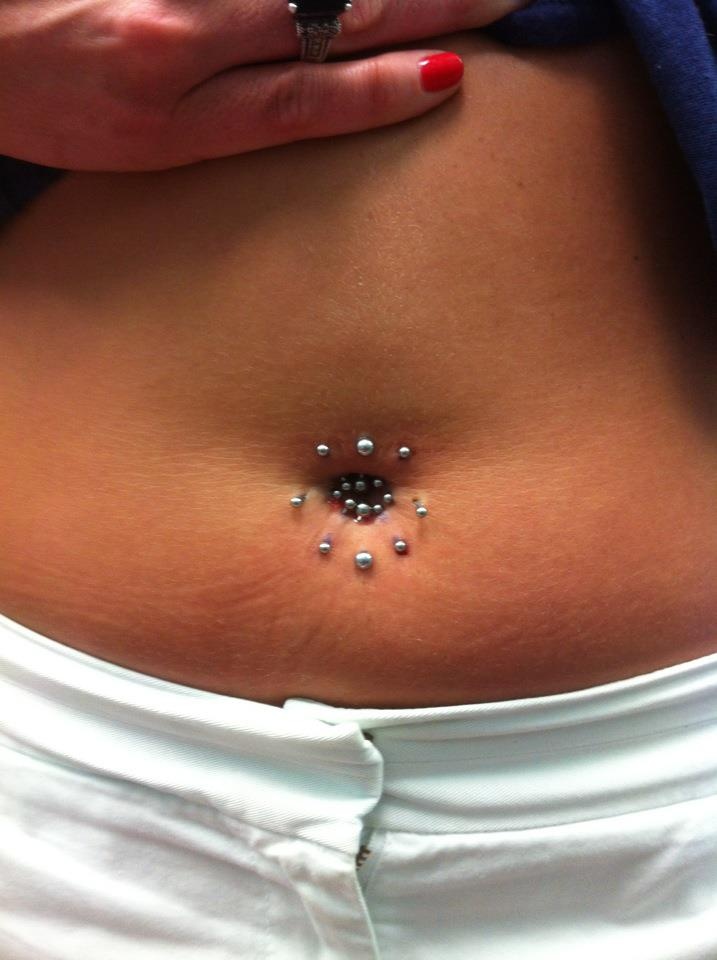 a woman's belly with small beads on it