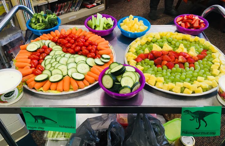 there are many different types of fruits and vegetables on the table in front of each other