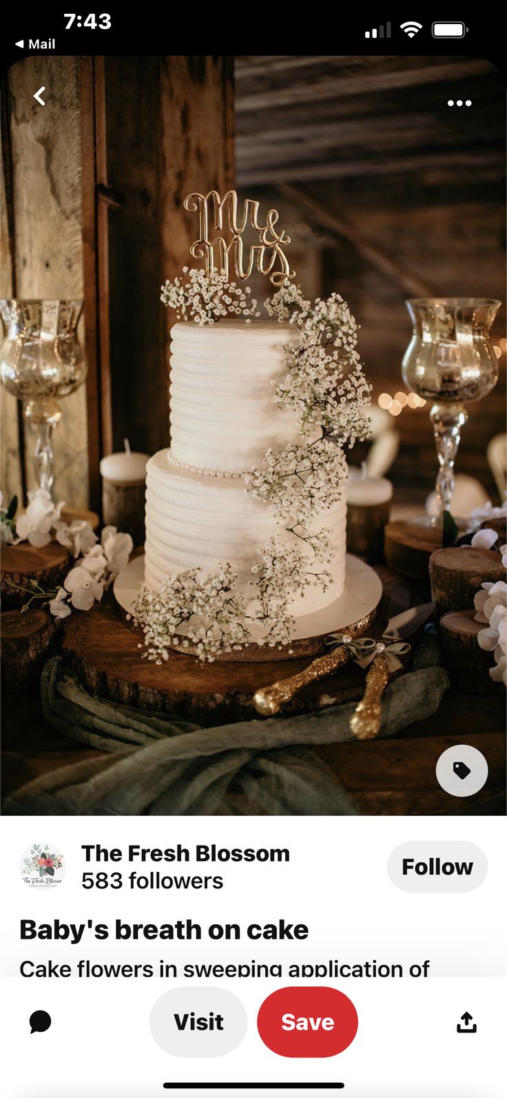 a white wedding cake sitting on top of a wooden table