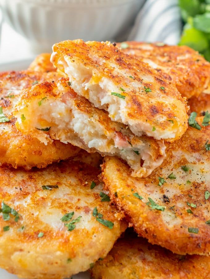 some crab cakes are stacked on top of each other and ready to be eaten by someone