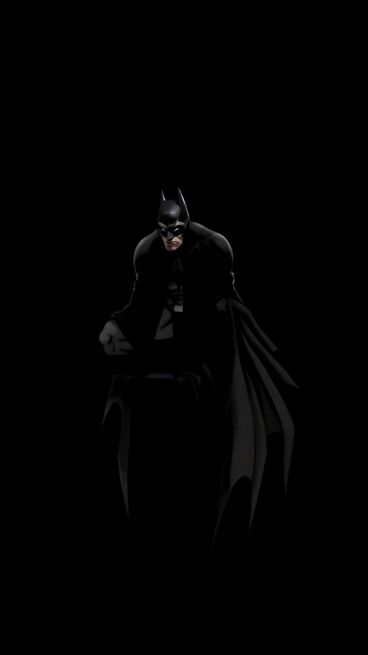 batman in the dark with his hands on his knees