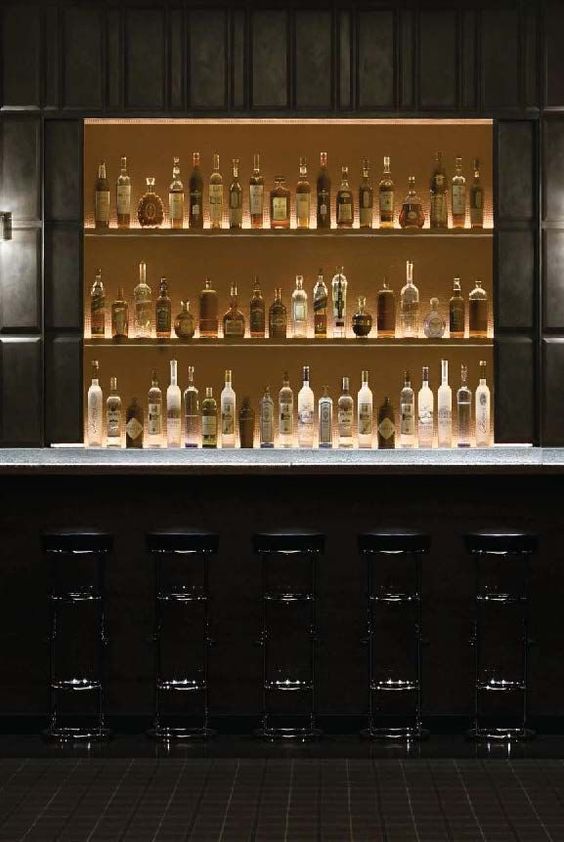 an empty bar with many bottles on it