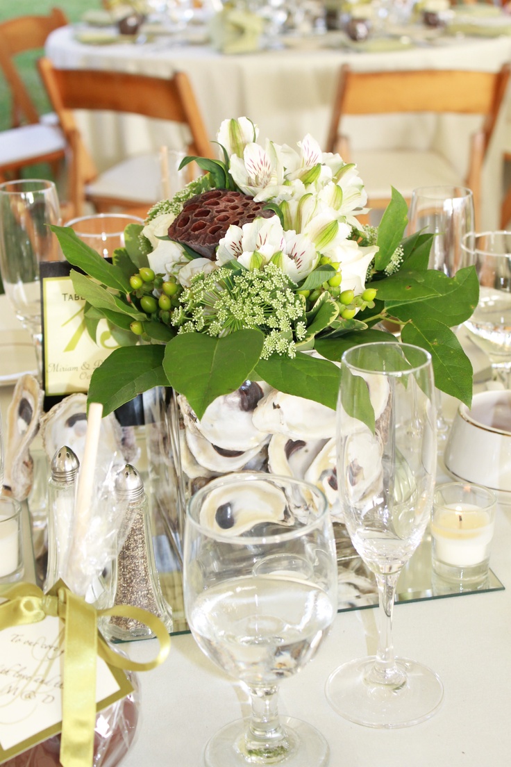 the table is set with white and green flowers