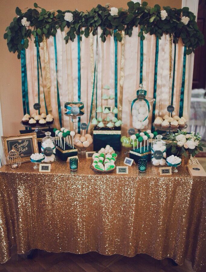 the dessert table is set up with green and white treats on it's side