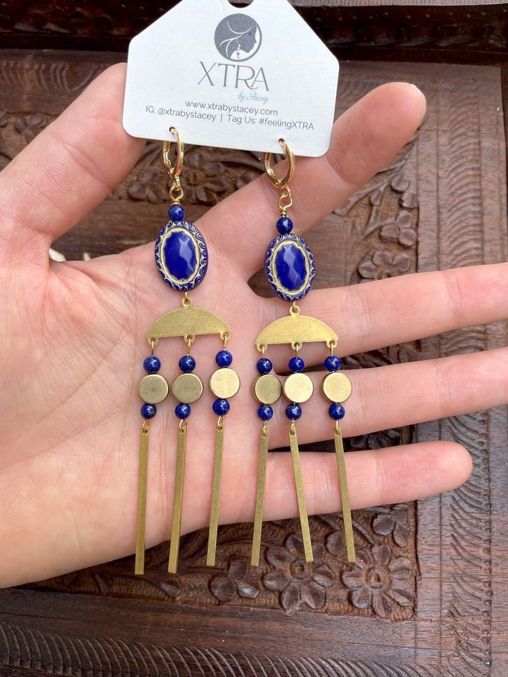 This listing is for long, dramatic, royal blue and gold chandelier earrings featuring vintage style etched beads, 4mm Lapis Lazuli stone beads, gold plated chain, and raw brass beads.Lapis Lazuli is known as the wisdom stone. It is thought to bring peace and harmony and encourage self-awareness and self-expression.These earrings hang approximately 4.0" inches from the lobe and measure about 0.75" inches across their widest point. The lever back closures are 22k gold plated and should be suitable Bohemian Adjustable Beaded Brass Earrings, Blue Beaded Brass Earrings As Gift, Handmade Gold Beaded Brass Earrings, Brass Wire Wrapped Dangle Earrings, Handmade Brass Dangle Chandelier Earrings, Wire Wrapped Brass Dangle Earrings, Handmade Brass Chandelier Dangle Earrings, Bronze Czech Glass Dangle Jewelry, Gift Blue Beaded Brass Earrings