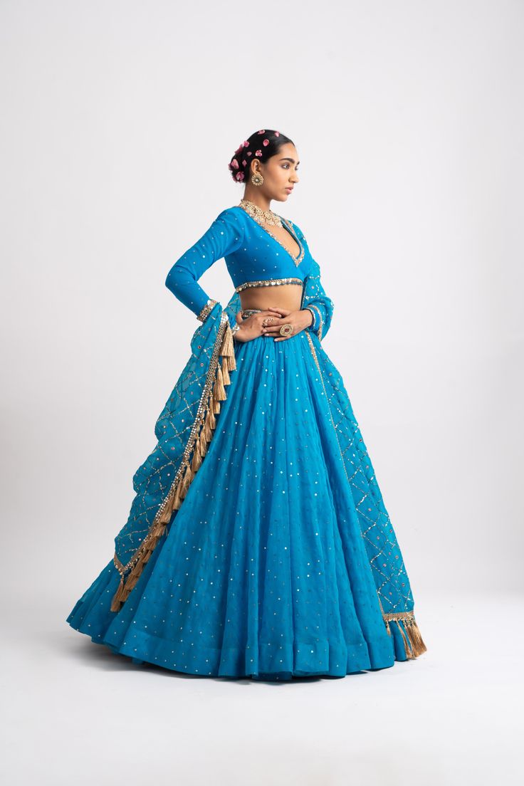 Intricately hand-embroidered heavy dupatta with zari jhallar detailing clubbed with a V-neck blouse and a silk organza lehenga.From Vvani Vats Rang's collection.DELIVERY TIMEPlease allow 8-12 weeks for your outfit to arrive.FABRIC DETAILSOrganza, Georgette, Silk BlendProfessional cleaning only. Choli With Sheer Dupatta For Reception Navratri, Blue Tissue Silk Dupatta With Gota Work, Reception Choli With Gota Work In Chanderi, Chanderi Choli With Gota Work For Reception, Fitted Organza Pre-draped Saree With Gota Work, Reception Choli In Chanderi With Gota Work, Chanderi Choli With Dupatta For Reception, Anarkali Pre-draped Saree With Gota Work, Pre-draped Organza Saree With Gota Work