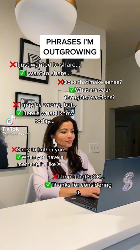 a woman sitting in front of a laptop computer on top of a white countertop