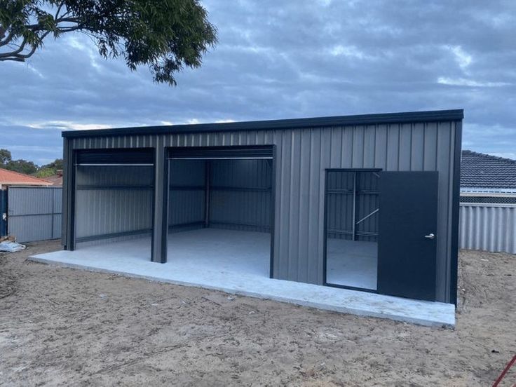 a metal building with two doors and one side open