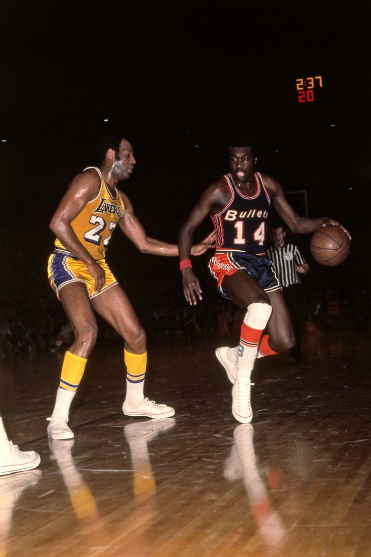 two basketball players in action on the court