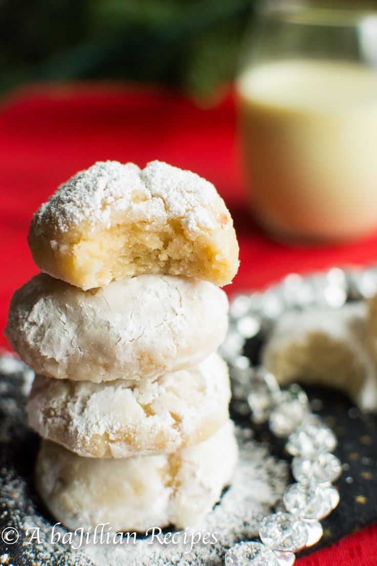 a stack of powdered sugar cookies sitting on top of a table